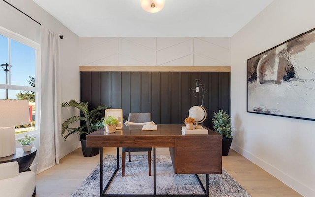 office area with light wood-style flooring and baseboards