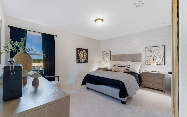 bedroom with visible vents, baseboards, and light colored carpet