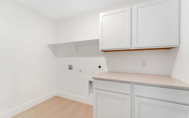 clothes washing area with baseboards, cabinet space, electric dryer hookup, washer hookup, and hookup for a gas dryer