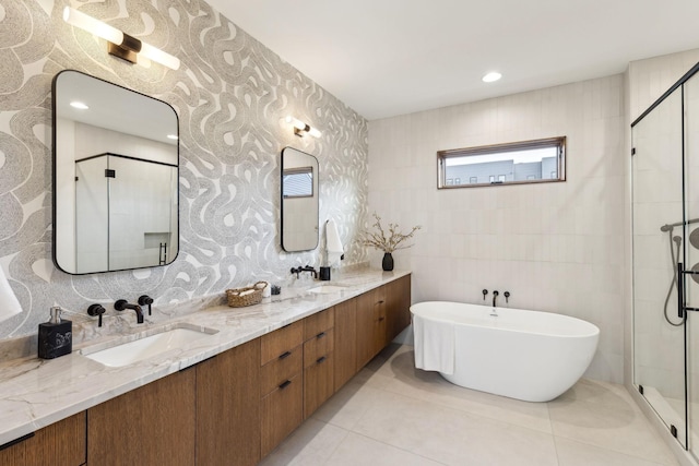 full bathroom featuring a stall shower, tile patterned flooring, and a sink