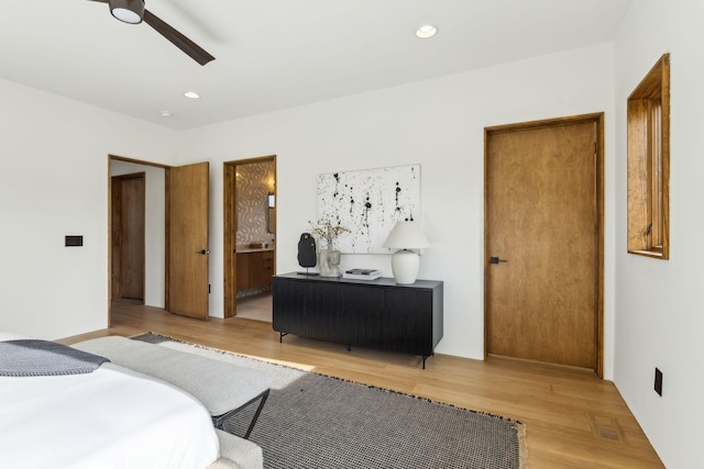 bedroom with light wood finished floors, recessed lighting, visible vents, ensuite bathroom, and ceiling fan