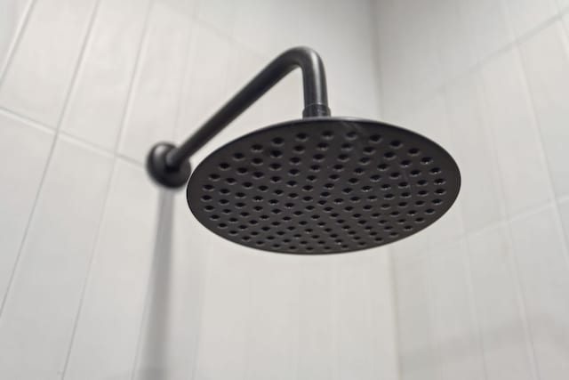 interior details with a tile shower