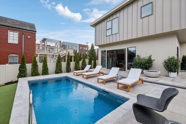 view of pool featuring a patio area, an outdoor fire pit, a fenced in pool, and a fenced backyard