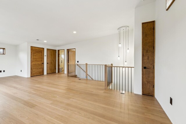 empty room featuring light wood-type flooring and recessed lighting