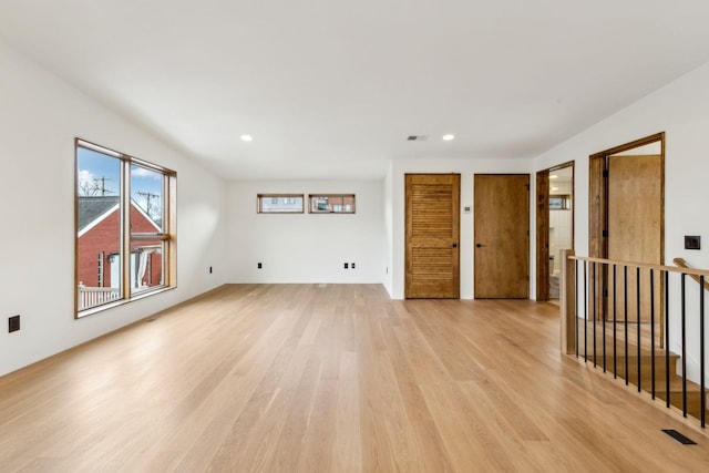 spare room with light wood-style floors, recessed lighting, and visible vents