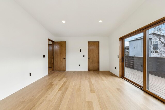 empty room featuring light wood-type flooring and recessed lighting