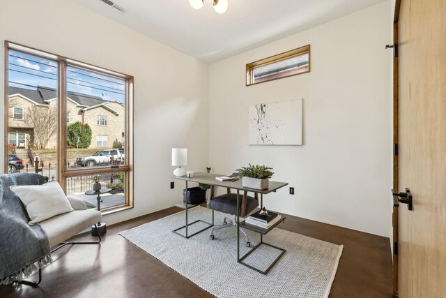 office area with concrete floors and visible vents