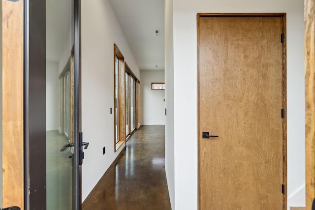 hall featuring concrete flooring