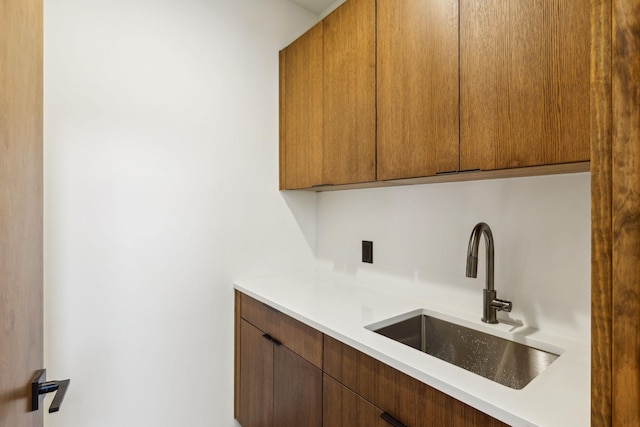 interior space with light countertops and a sink