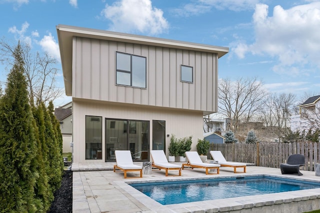 back of house featuring a patio area and fence