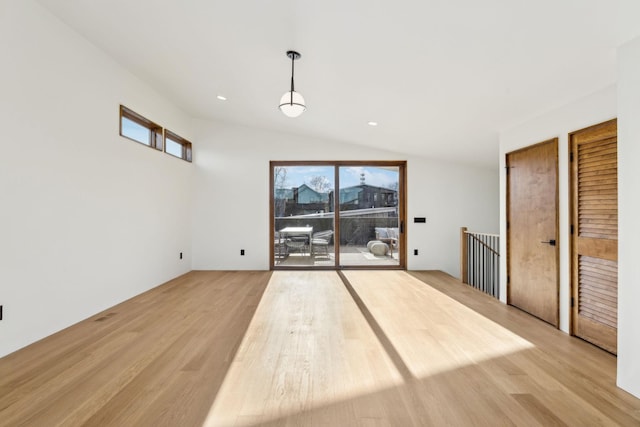 interior space with lofted ceiling, light wood finished floors, and recessed lighting