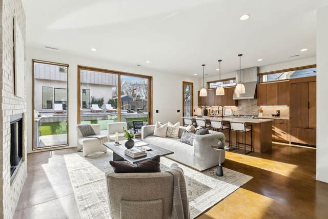 living area with a healthy amount of sunlight, concrete floors, and recessed lighting