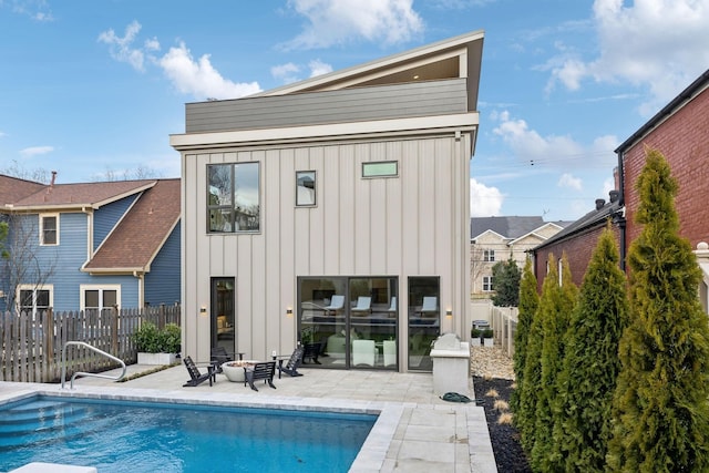 back of property featuring a patio, board and batten siding, a fenced backyard, and a fenced in pool