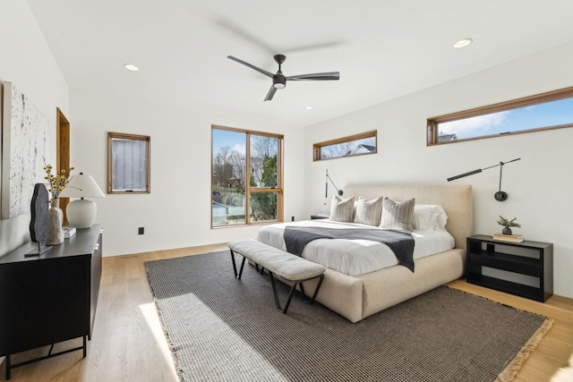 bedroom with light wood finished floors, a ceiling fan, and recessed lighting