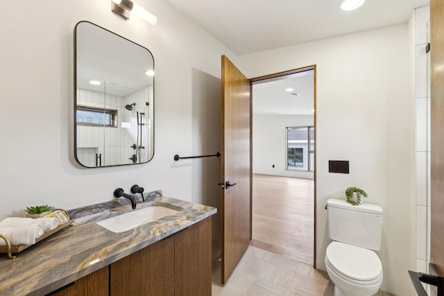 full bath featuring recessed lighting, vanity, and toilet