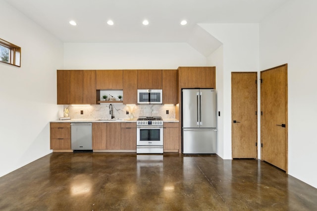 kitchen featuring stainless steel appliances, finished concrete floors, brown cabinets, and a sink