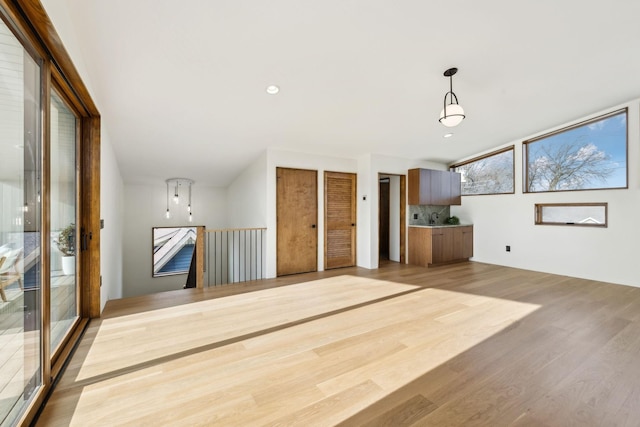 unfurnished living room featuring light wood finished floors and recessed lighting