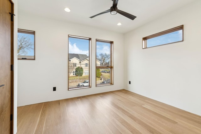 unfurnished room with light wood-style flooring, a ceiling fan, and recessed lighting