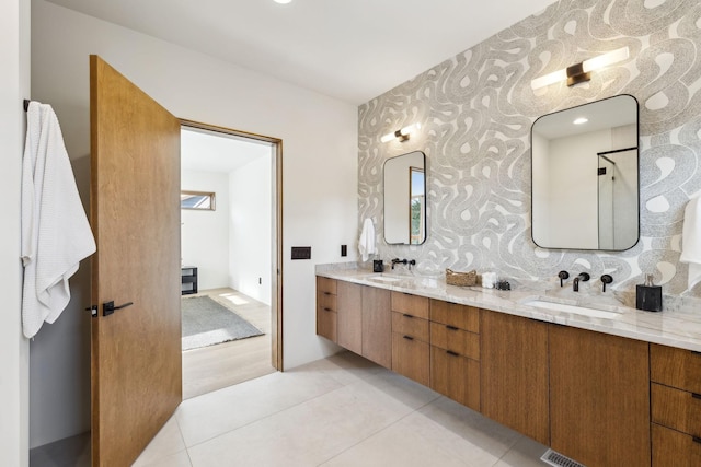 bathroom featuring tile patterned floors, a sink, and double vanity