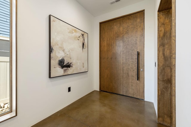 hall featuring concrete flooring