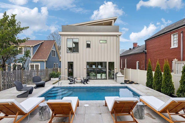 view of swimming pool with a fenced in pool, a fenced backyard, and a patio