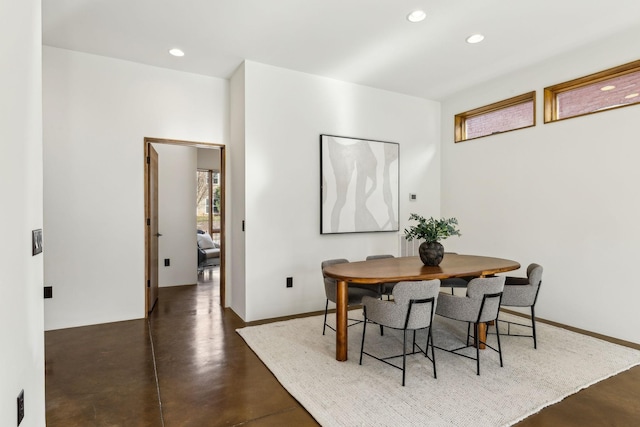 dining area with recessed lighting, finished concrete flooring, and baseboards