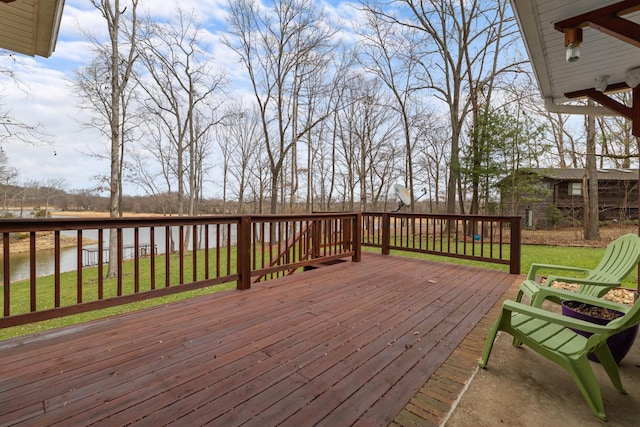 wooden terrace featuring a lawn