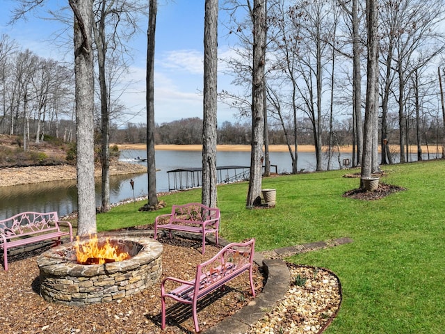 view of yard with a fire pit and a water view