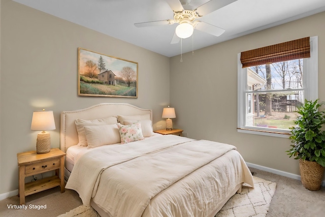 carpeted bedroom with a ceiling fan and baseboards