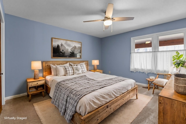 bedroom with a ceiling fan, baseboards, and carpet floors