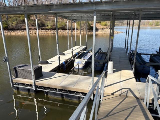 dock area with boat lift and a water view