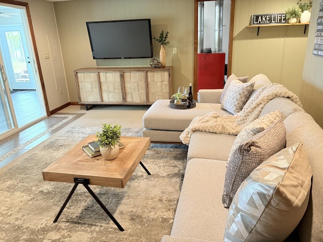 living room with wood walls and baseboards