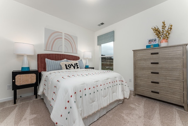 carpeted bedroom with baseboards and visible vents