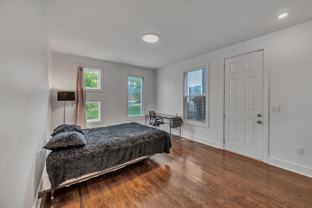 bedroom featuring baseboards and wood finished floors