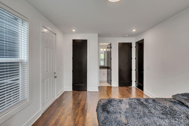 bedroom featuring ensuite bath, baseboards, wood finished floors, and recessed lighting