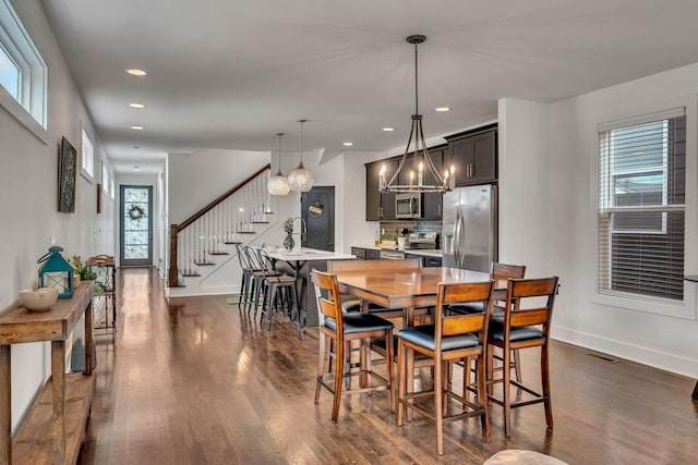 dining room with stairs, visible vents, dark wood-type flooring, and recessed lighting