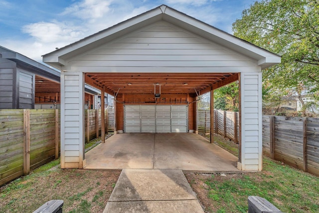 exterior space with a detached garage and fence