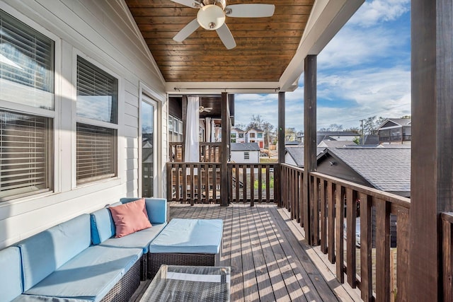 wooden deck with a residential view, outdoor lounge area, and ceiling fan