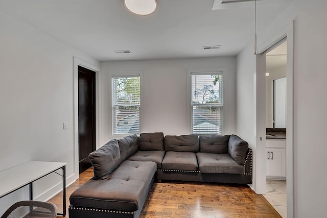 living area featuring a wealth of natural light and visible vents