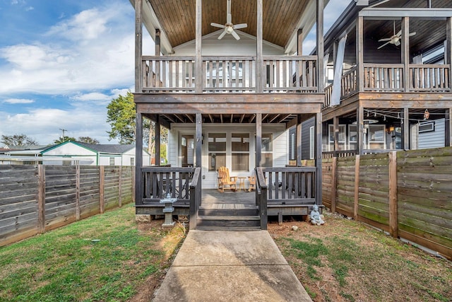 back of property with ceiling fan, a deck, and a fenced backyard