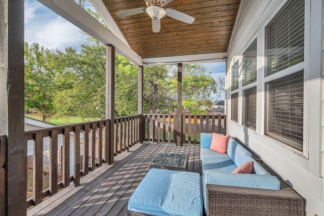 deck with an outdoor living space and a ceiling fan