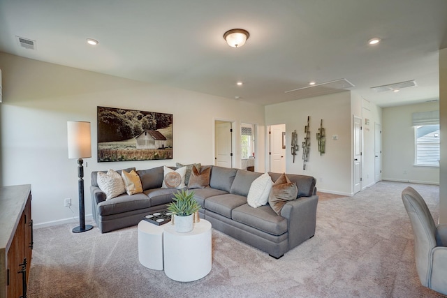 living room with attic access, light colored carpet, visible vents, and recessed lighting