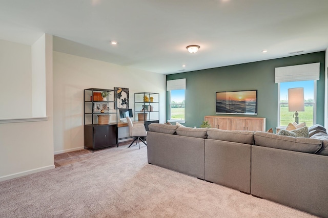 carpeted living room featuring a healthy amount of sunlight, visible vents, baseboards, and recessed lighting