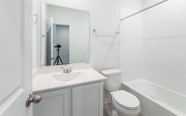 bathroom featuring shower / bathtub combination, toilet, and vanity