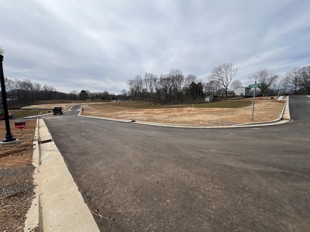 view of road with curbs and traffic signs