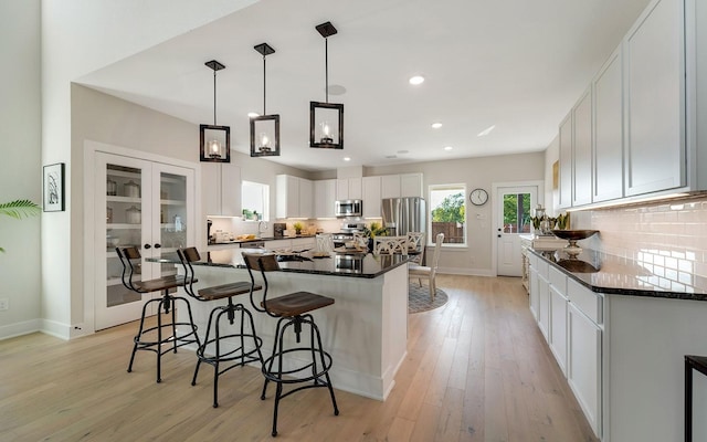 7228 Fairlawn Dr, Fairview, TN 37062 - kitchen with appliances with stainless steel finishes, a center island, tasteful backsplash, a kitchen bar, and recessed lighting