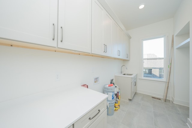 laundry area featuring hookup for a washing machine, recessed lighting, a sink, baseboards, and cabinet space