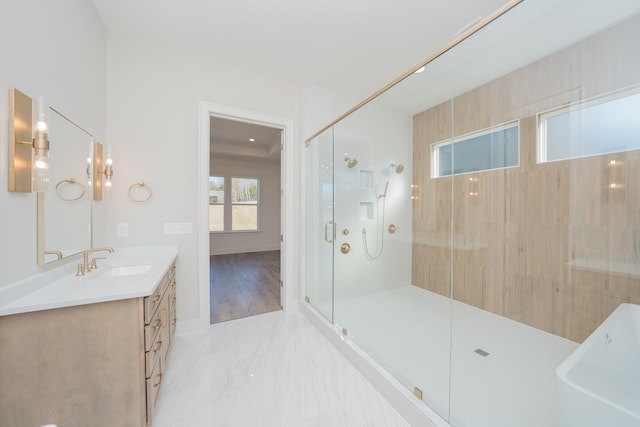 bathroom with a freestanding bath, marble finish floor, an enclosed shower, and vanity