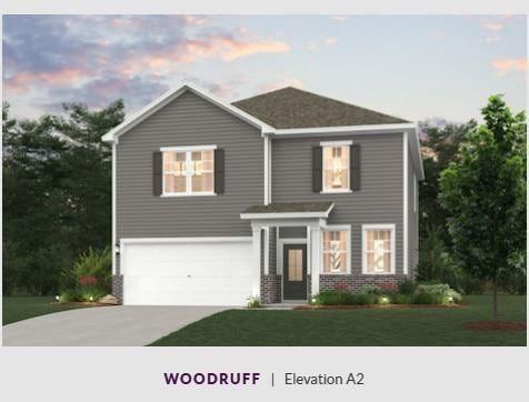 view of front of property featuring a garage, driveway, brick siding, and a front yard