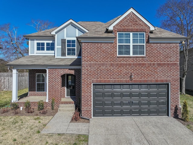 traditional-style home featuring brick siding, a porch, concrete driveway, an attached garage, and fence